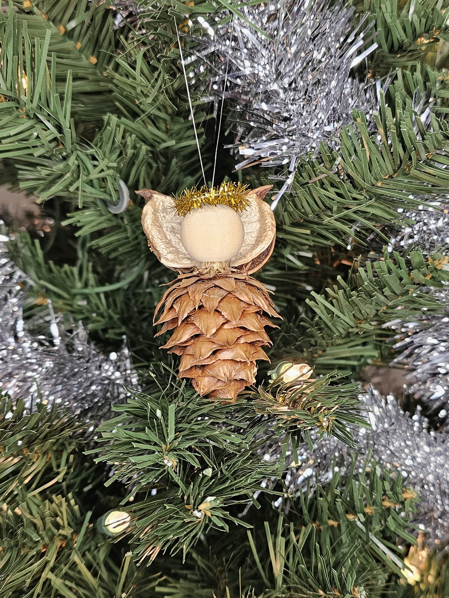 Gold handmade China Fir Tree Cone Angel Christmas Ornament on a Christmas Tree