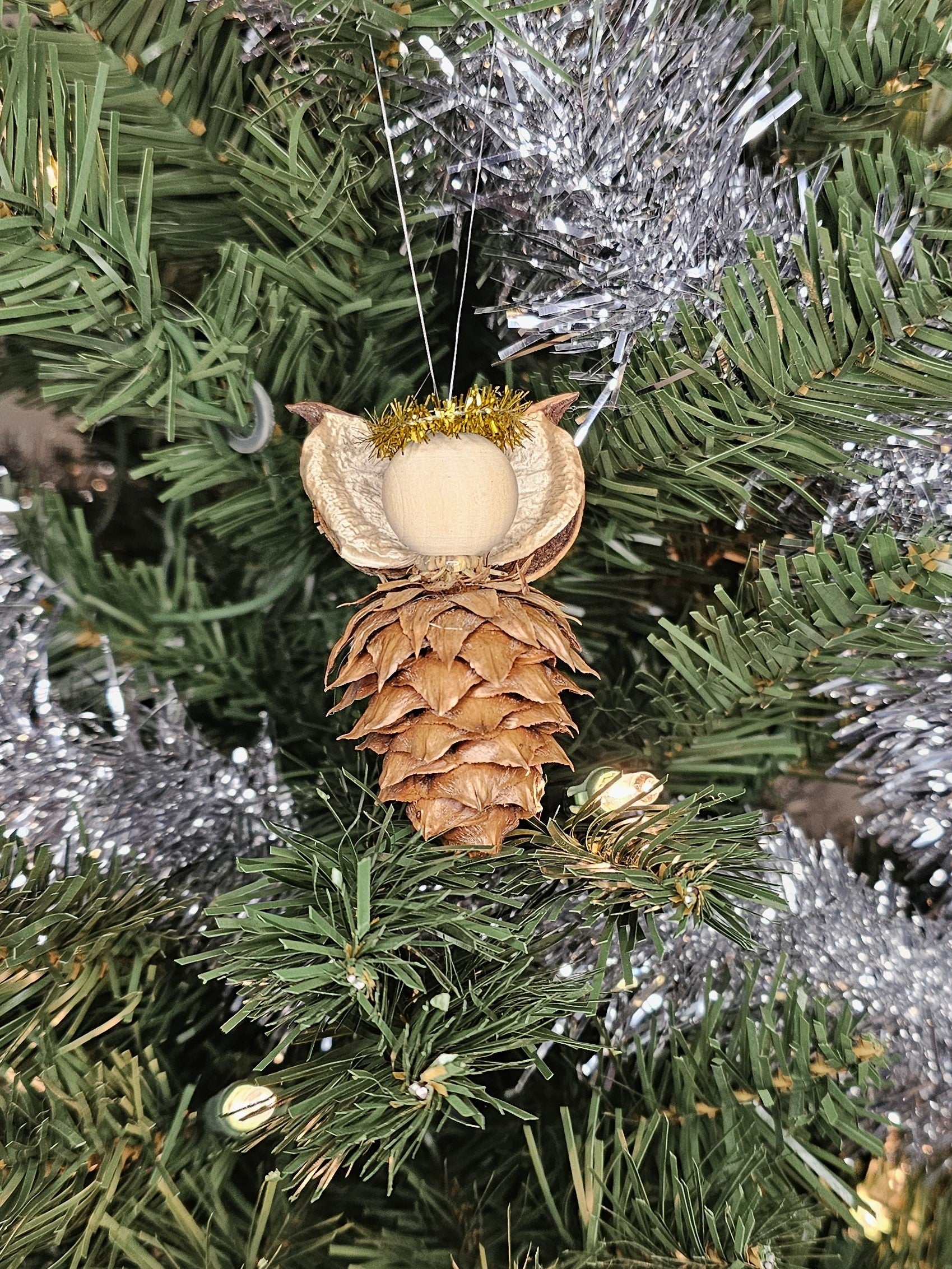 Gold handmade China Fir Tree Cone Angel Christmas Ornament on a Christmas Tree