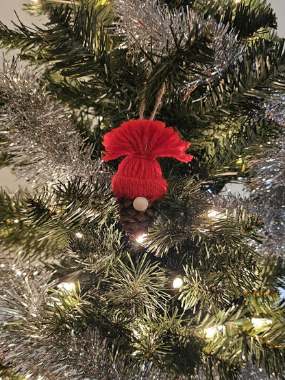 Handmade China Fir Tree Cone Gnome Christmas Ornament with a red hat on a Christmas tree